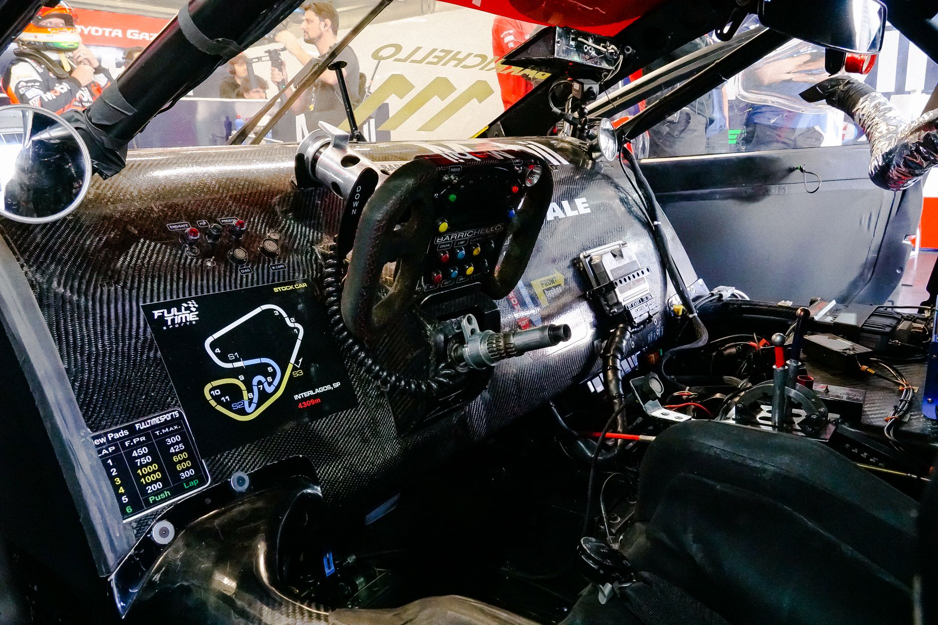 Stripped-out track weapon interior with roll cage, bucket seat and bare metal shell